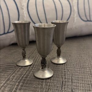 Set of Three Silver-colored silver cups.